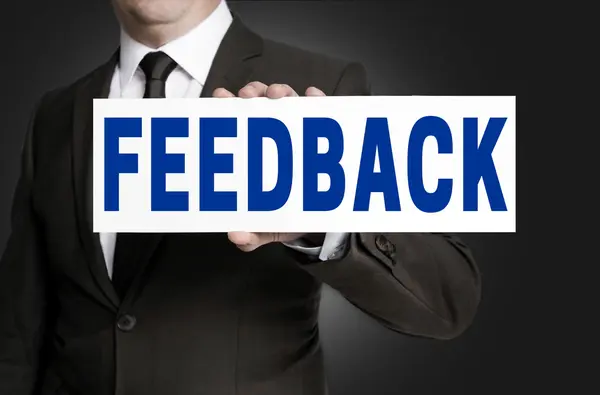Feedback sign is held by businessman background — Stock Photo, Image