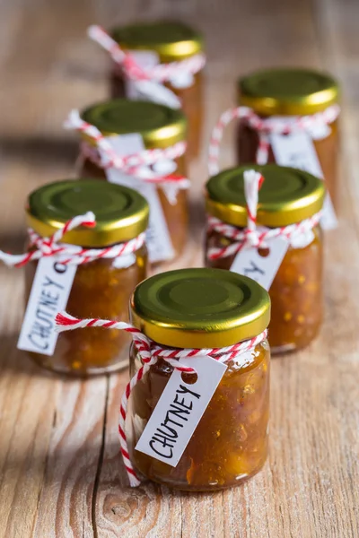 Onion pineapple chutney on rustic wood — Stock Photo, Image