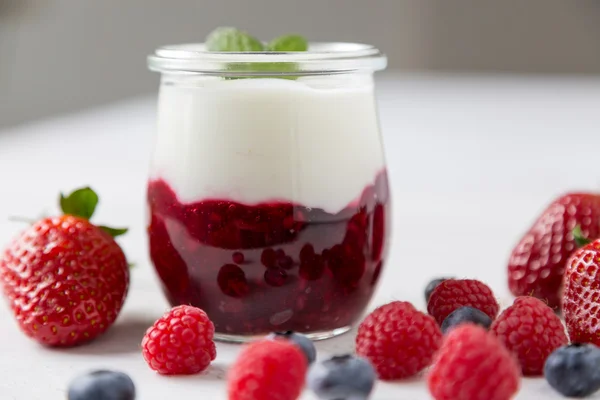 Red fruit compote with mint leaves and fruit.