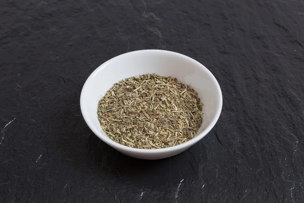 Provencal herbs in a bowl on a slate — Stock Photo, Image