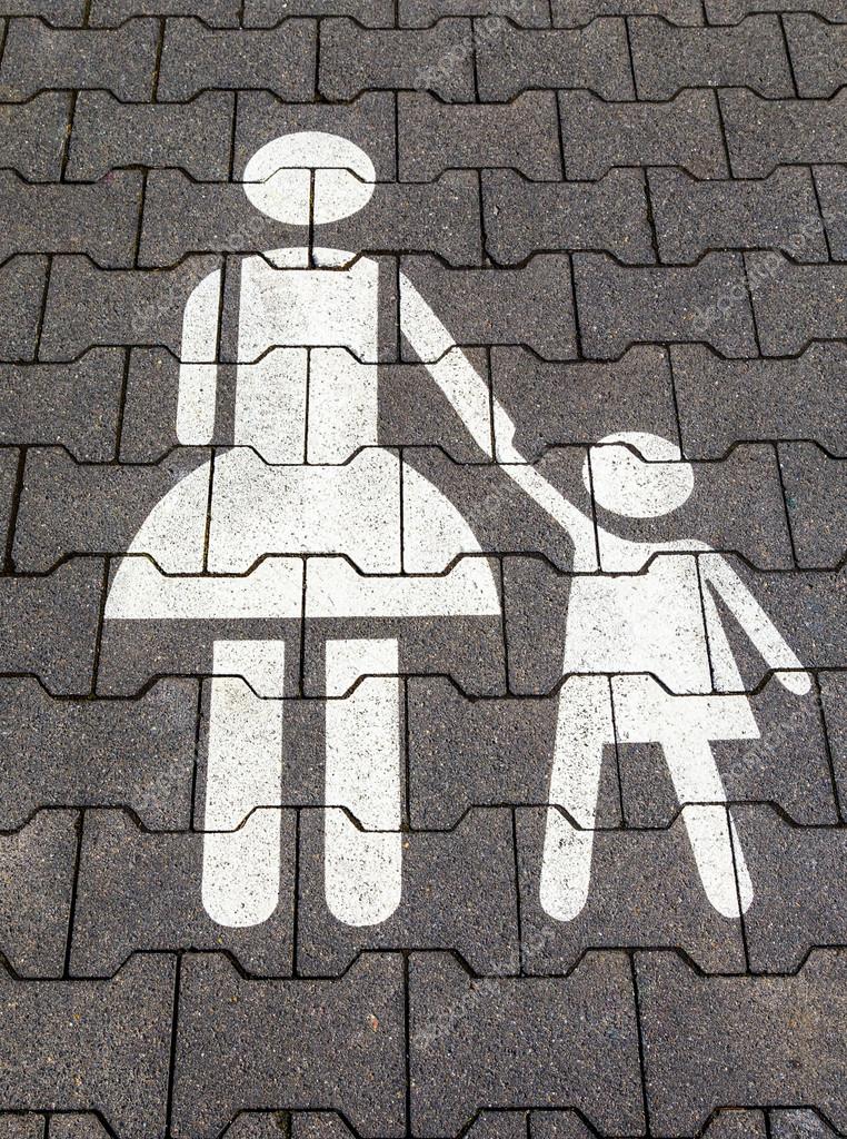 Mother and child symbol in a parking lot