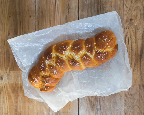 Braided Bread on rustic wood and parchment paper — Stock Photo, Image