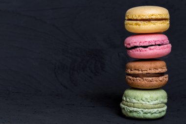 Siyah ahşap üzerine renkli macarons