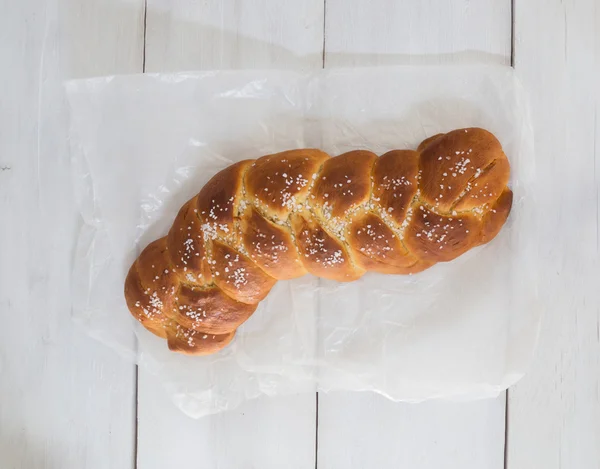 Braided Bread on white wood and baking paper — Stock Photo, Image