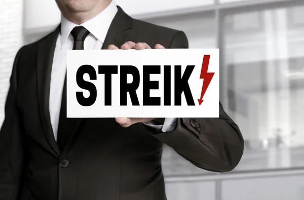 Businessman holding strike sign to viewer — Stock Photo, Image