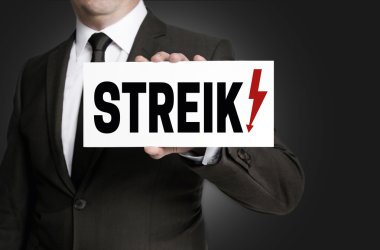 Strike sign is held by businessman clipart