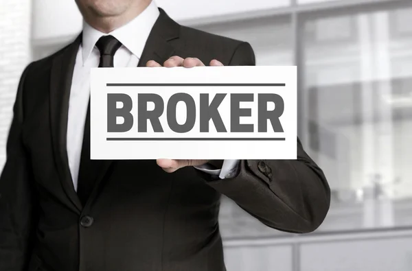 Broker sign is held by businessman. — Stock Photo, Image