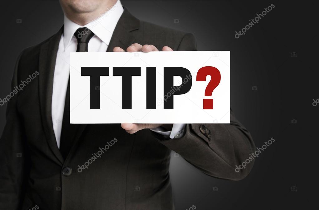 TTIP sign is held by businessman.