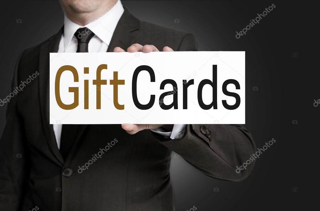 Gift Cards sign is held by businessman