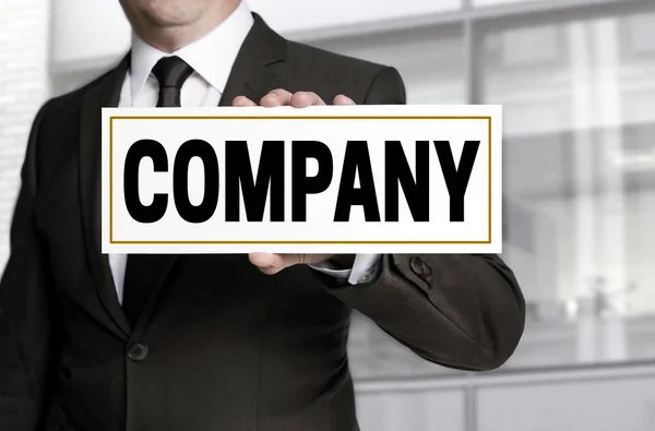 Company sign is held by businessman — Stock Photo, Image