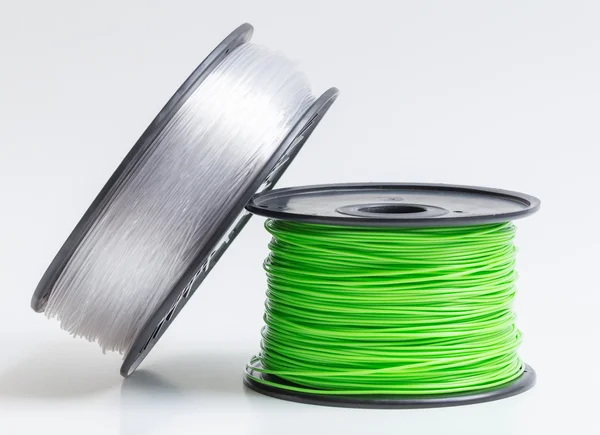 Filament pour imprimante 3D cristal clair et vert vif contre un — Photo