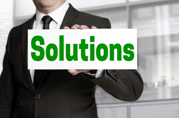 Solutions sign is held by businessman — Stock Photo, Image