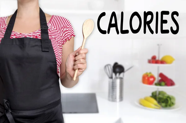 Calorías cocinar sosteniendo fondo cuchara de madera — Foto de Stock