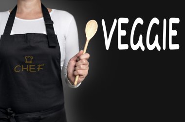 tahta kaşık arka planda tutan veggie Şef
