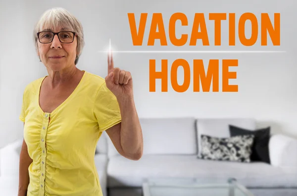 Vacation home touchscreen is shown by senior — Stock Photo, Image