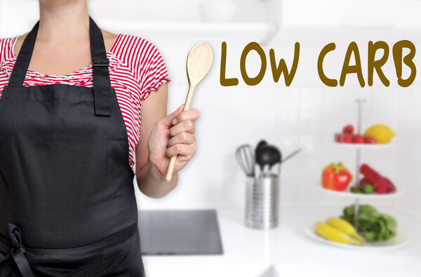 low carb cook holding wooden spoon background concept