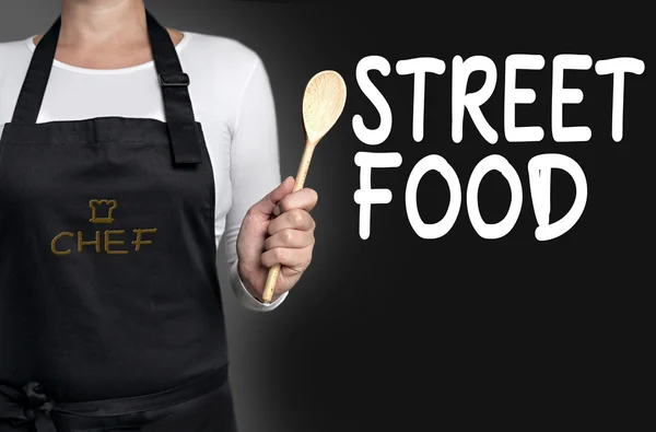Street food cook holding wooden spoon background concept — Stock Photo, Image