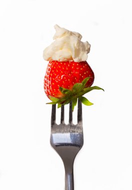 Strawberry with cream on a fork macro isolated clipart