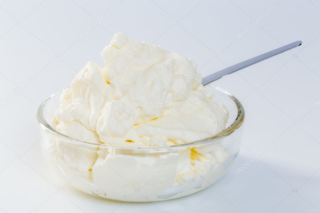 cream in a glass bowl isolated concept.