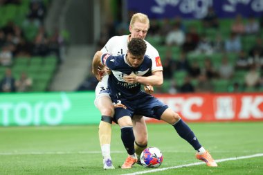 MELBOURNE, AUSTRALIA - 18 Ekim 2025: Auckland FC 'den Francis De Vries ve Melbourne Victory' den Clerismario Santos Rodrigues, A-League Mens 'de Melbourne Victory ile Auckland FC arasında oynanan maçta mücadele ediyorlar.