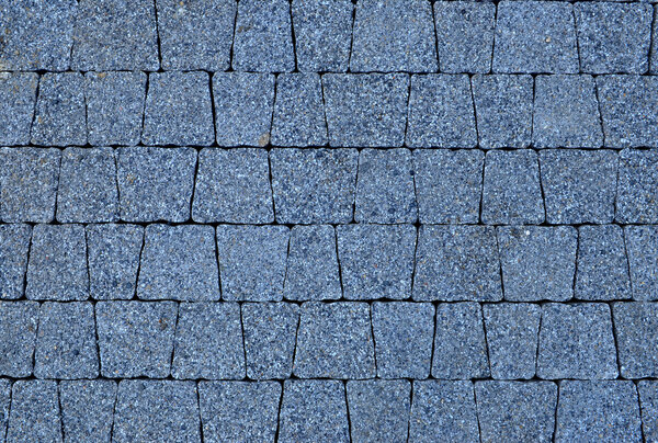 Granite cobblestoned pavement background texture. Stone Block