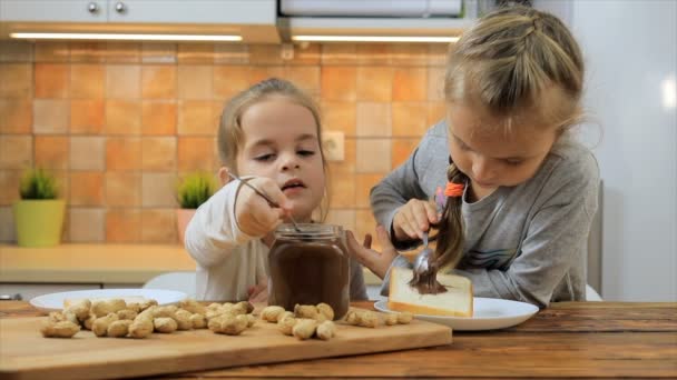 Bambine che preparano panino con burro di arachidi e lo mangiano — Video Stock