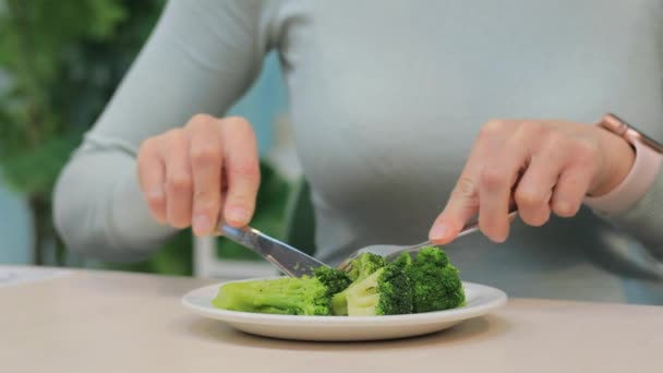 Femme végétalienne manger du brocoli dans le café — Video