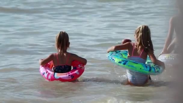 두 여동생 이 함께 바다에서 수영을 하고 있다 — 비디오