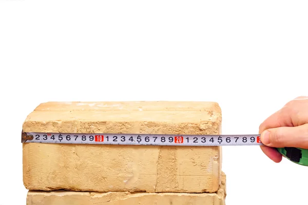 Brick and ruler isolated on white — Stock Photo, Image
