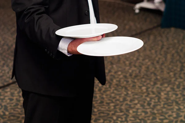 Waiter holding plate — Stock Photo, Image