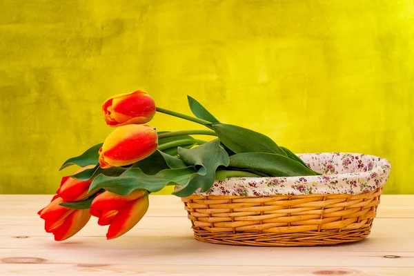 Colorful tulip on wooden table in basket — Stock Photo, Image