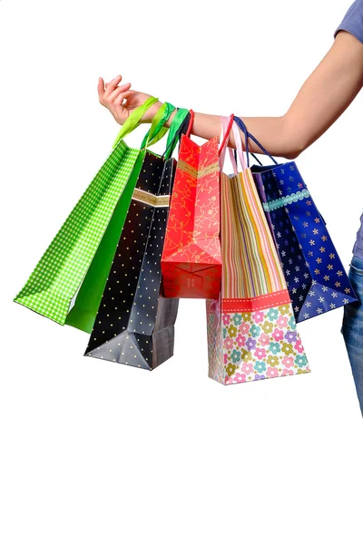 Mano femenina sosteniendo bolsas de compras multicolor — Foto de Stock