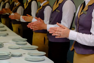 Close-up of waiters clapping hands. Seminar concept. clipart