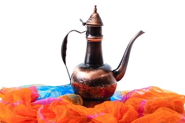 Caraffa orientale su un panno arancio drappeggiato — Foto Stock