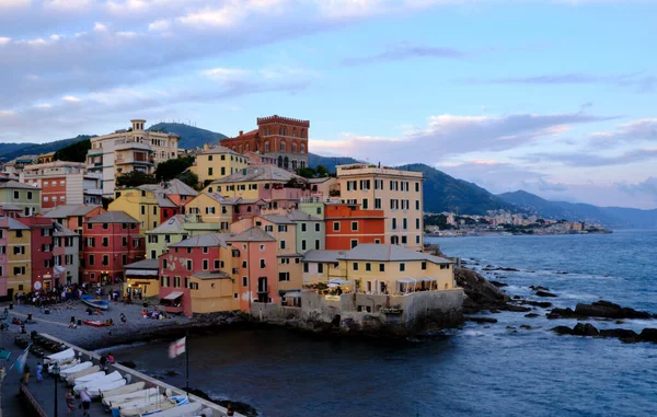 Boccadasse sahilinin renkli evleri ve arkasında yumuşak dalgalar olan uzun pozlu bir fotoğrafı. Cenova, Ligurie, İtalya