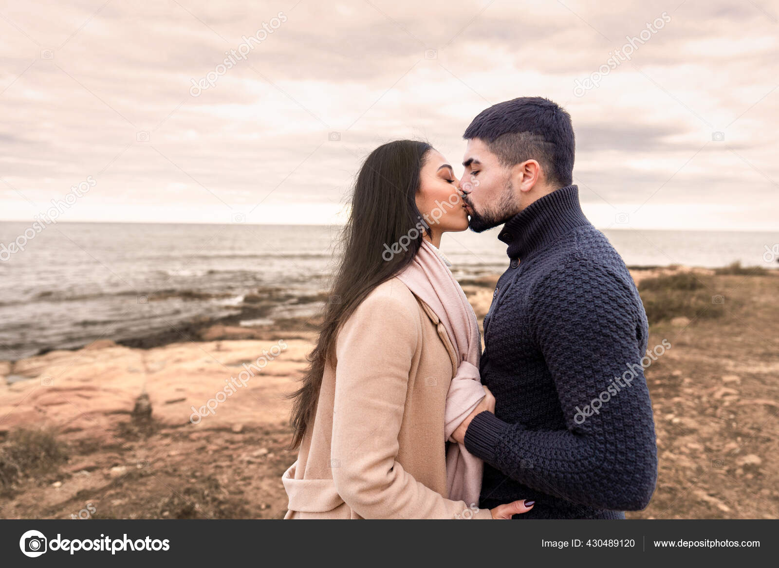 Mixed Race Couple Romance Scene Sea Rocks Cloudy Sky Sunset Stock Photo