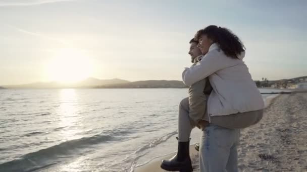 一对情侣在度假胜地欣赏大海日落时的60英尺慢镜头 美丽的非洲裔美国女孩站在她英俊男友的肩上 — 图库视频影像