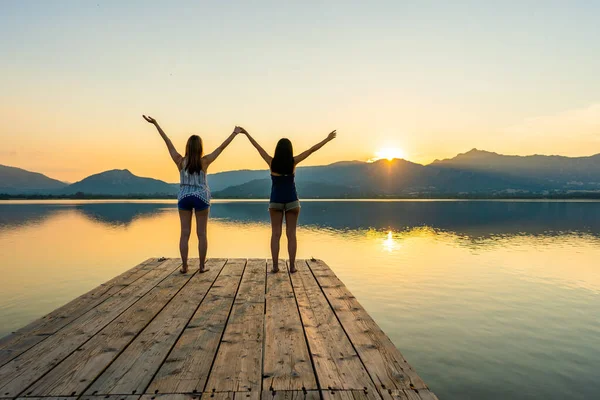 Two Girls Focused Spiritual Meditation Looking Setting Sun Standing Wooden — Stock Photo, Image