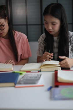 Masada ödev yapan iki kız öğrenci..