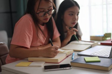 Ev ödevlerini birlikte yapan kız öğrenciler..