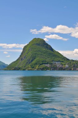 Güzel Monte San Salvatore (San Salvatore Dağı olarak da bilinir) ve güneşli bir günde Lugano Gölü 'nün portre görüntüsü