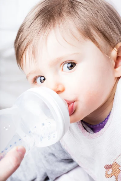 Baby eating from her baby bottle Royalty Free Stock Photos