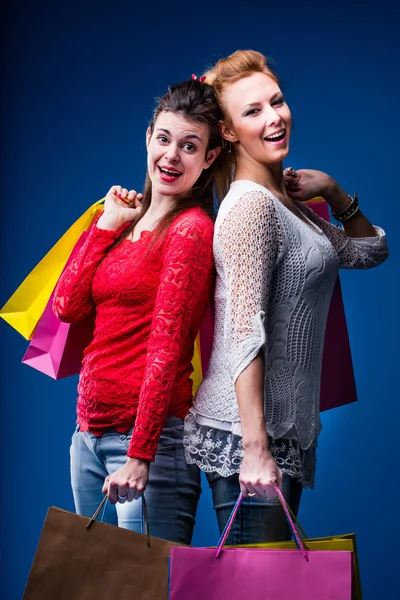 Women shopping with lots of bags on blue — Stock Photo, Image