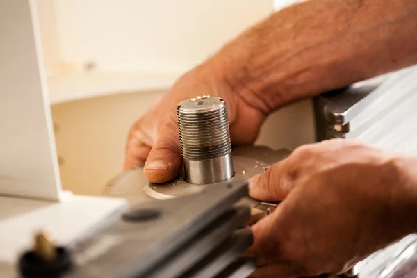 Hand of a woodworker setting up a milling cutter — Stock Photo, Image