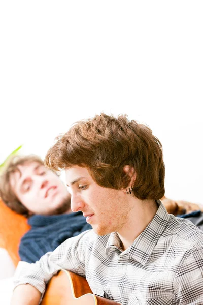 Handsome young man playing guitar — Stock Photo, Image