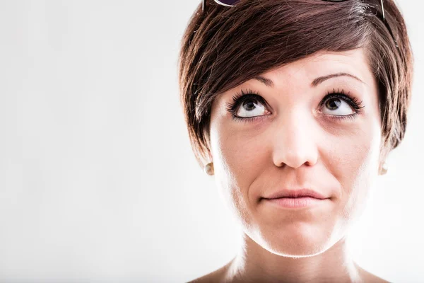 Thoughtful woman looking up into the air — Stock Photo, Image