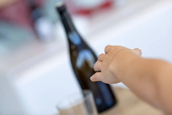 Hand Reaching Bottle Wine Table Indoors Tilted Angle View Focus — Stock Photo, Image