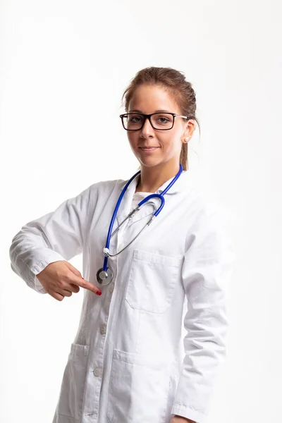 Smiling Female Doctor Nurse Wearing Glasses Stethoscope Pointing Her Herself — Stock Fotó