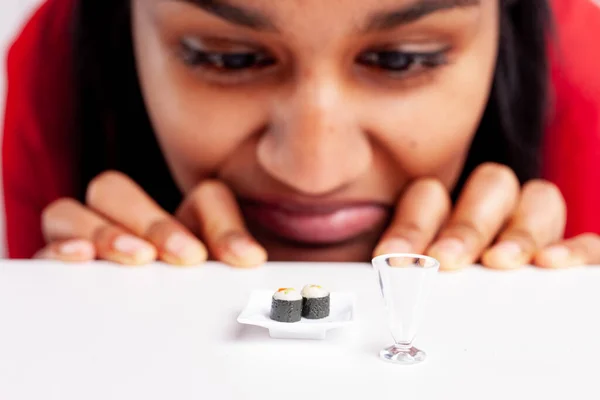 Young Woman Aversion Sushi Fun Concept Using Miniature Food Plate — Stockfoto