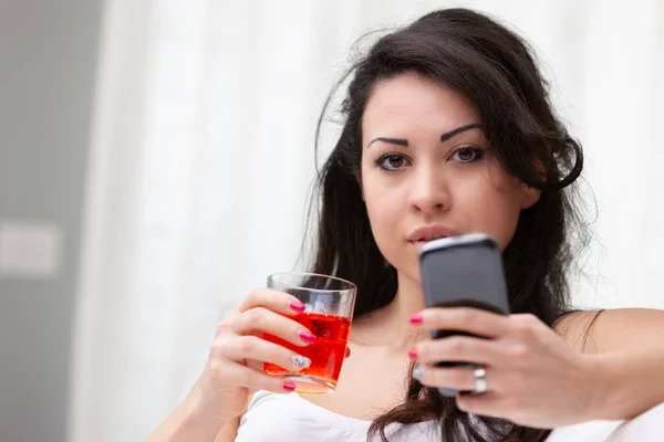 Giovane Donna Godendo Cocktail Durante Utilizzo Del Suo Telefono Cellulare — Foto Stock